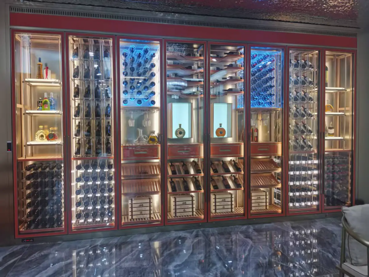 Red framed glass door wine wall with bottle racking, spirits display and drawers